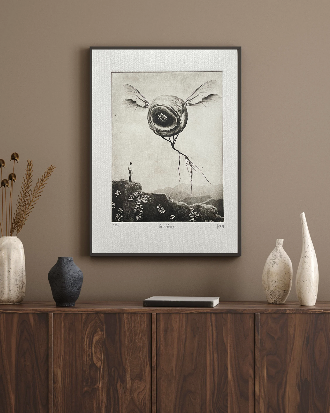 Custom Framed artwork on a wall above a wooden console table with decorative vases. Versus Arts Framing